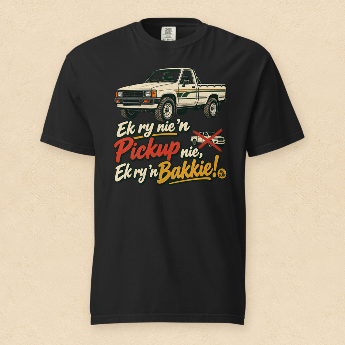 Ek ry nie ’n pickup nie, ek ry ’n bakkie! — Black shirt on cream wall